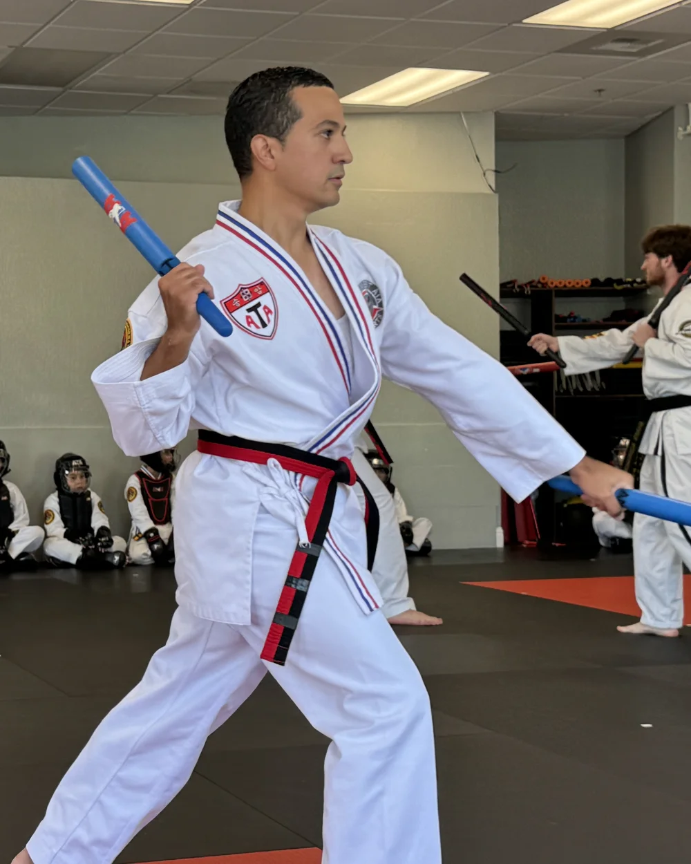 Adult black belt student practicing an advanced form with escrima sticks at Element ATA Martial Arts in Martinez CA